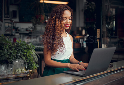 Buy stock photo Laptop, working and black woman typing at a cafe, networking on the internet and planning work at a coffee shop. African business owner and manager on web for stock at a restaurant with a computer