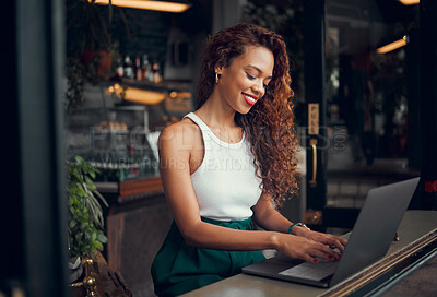 Buy stock photo Laptop, internet cafe and typing with a black woman blogger working at the window of a coffee shop on an article or report. Computer, email and remote work with a female writer busy in a restaurant 