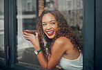 Coffee shop, window and drink with a black woman in a restaurant to relax alone on the weekend. Cafe, happy and face with a young African American female drinking from a mug or cup with a smile