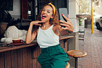 Selfie, phone and coffee shop with a black woman taking a photograph for social media post. 5g mobile technology, cafe and app with a female customer taking a picture at an outdoor restaurant
