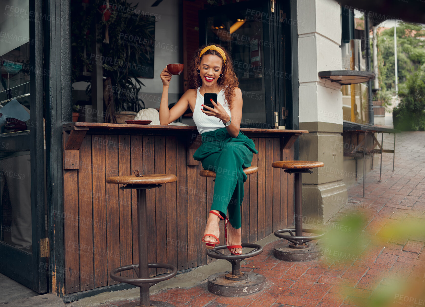 Buy stock photo Phone, social media and coffee with a black woman customer at a cafe counter on the sidewalk. Coffee shop, internet and communication with a young female typing a text message in a restaurant 