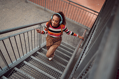 Buy stock photo City, music and girl on stairs, phone in hand and listening to audio. Happy black woman with headphones streaming song, track or radio on smartphone in urban town, student freedom on weekend