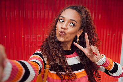 Buy stock photo Fashion selfie, peace sign and happy woman against a red wall in city for fun travel holiday. Portrait urban girl show cool hand gesture and lips while traveling and sharing picture on social media