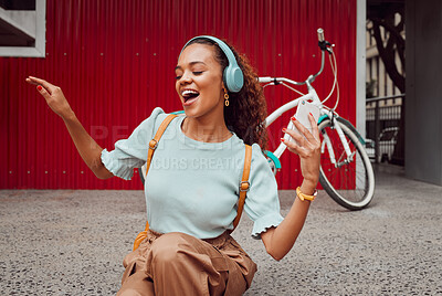 Buy stock photo Headphones, music and happy woman singing in the city while streaming audio or radio online. Happiness, excited and girl from Puerto Rico listening to a track while sitting on pavement in urban town.