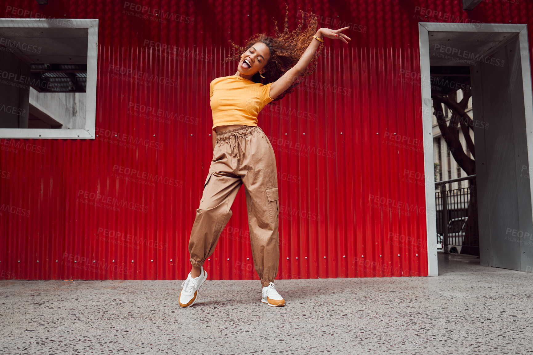 Buy stock photo Dance, freedom and fun with a black woman on a red background, dancing or happy with a smile while moving to music. Dancer, free and expression with an attractive young female in rhythmic movement