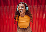 Relax, urban and woman with headphone music enjoying happy rhythm with bluetooth connection. Smile of latino girl listening to feel good streaming while resting at wall for leisure break.

