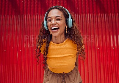 Buy stock photo Urban, joy and woman with headphone music enjoying happy rhythm with bluetooth connection. Smile of latino girl listening to feel good streaming audio while resting at wall for leisure break.

