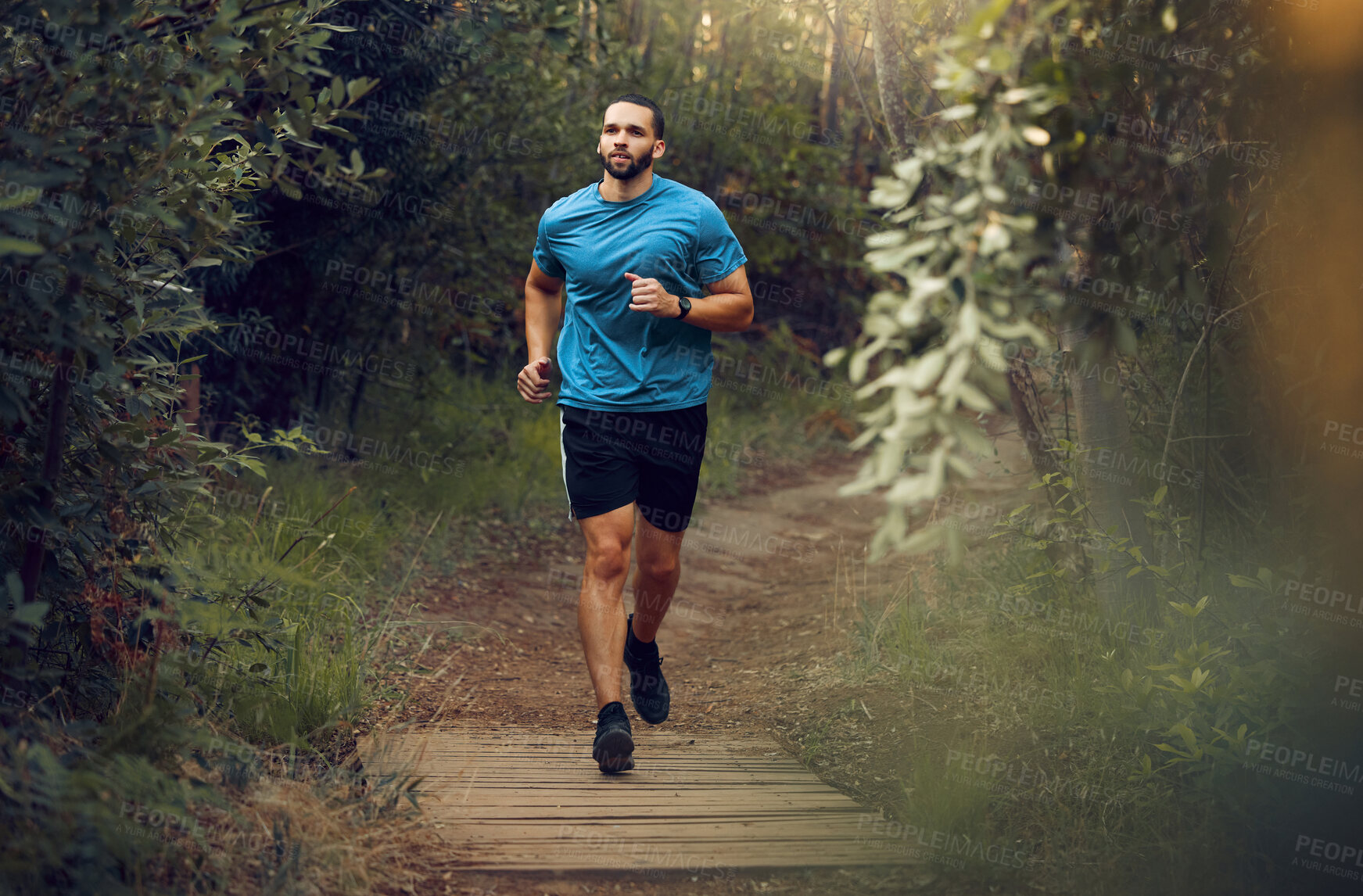 Buy stock photo Fitness, man and running in nature for healthy exercise, training and workout in the outdoors. Active, athletic male runner in sports taking a jog in the forest or park for health and cardio wellness