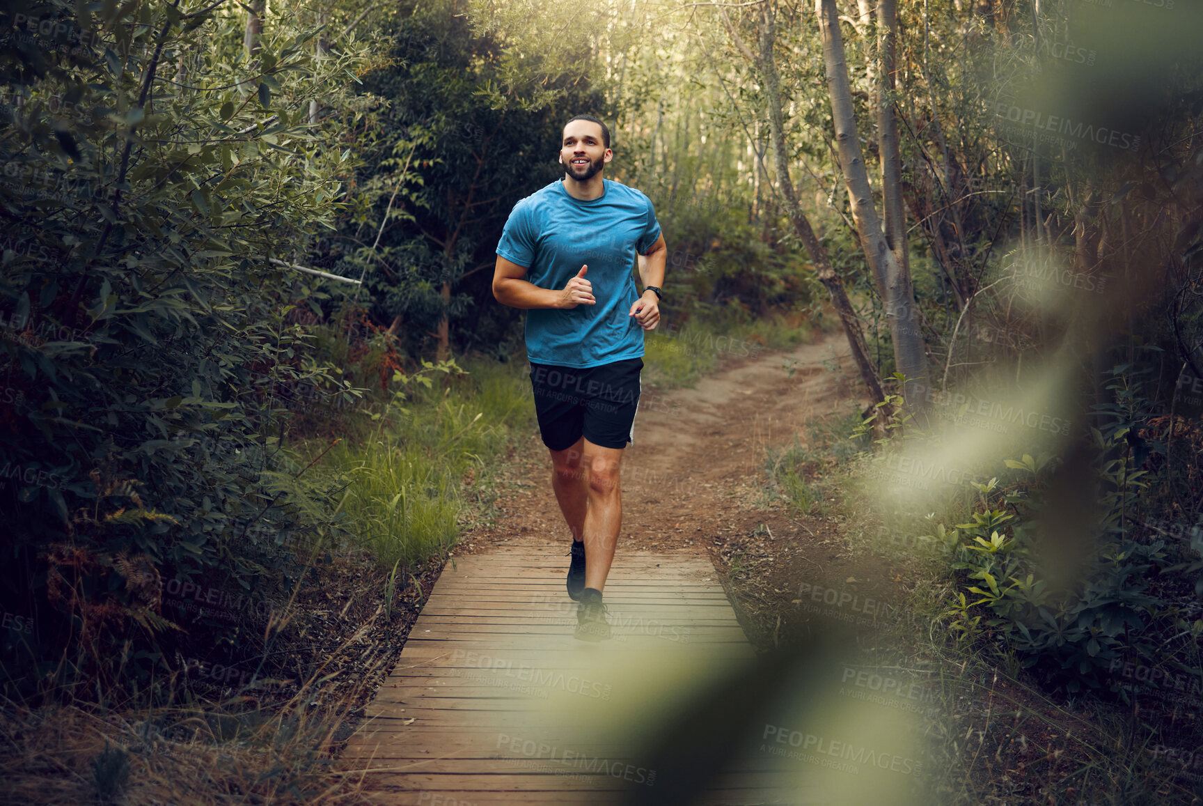 Buy stock photo Man, running and fitness on forest path, nature woods bridge or countryside environment for health, wellness or heart health. Smile, happy or sports runner in exercise, training and workout in Canada