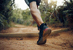 Hiking, nature park trail running and fitness runner on a dirt  walking road outdoor. Training, exercise and sport man on a cardio, healthy and strong workout of an athlete on a morning doing sports