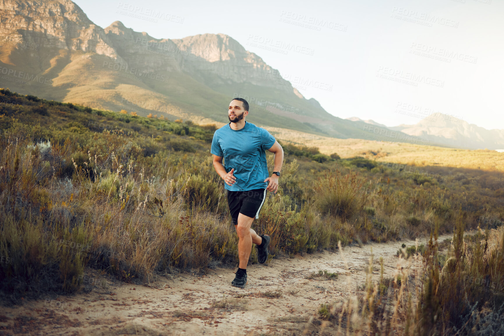 Buy stock photo Health, mountain and man running in nature for fitness, training and sports exercise. Workout, wellness and summer with athlete runner in grass field path for peace, marathon and outdoor morning jog