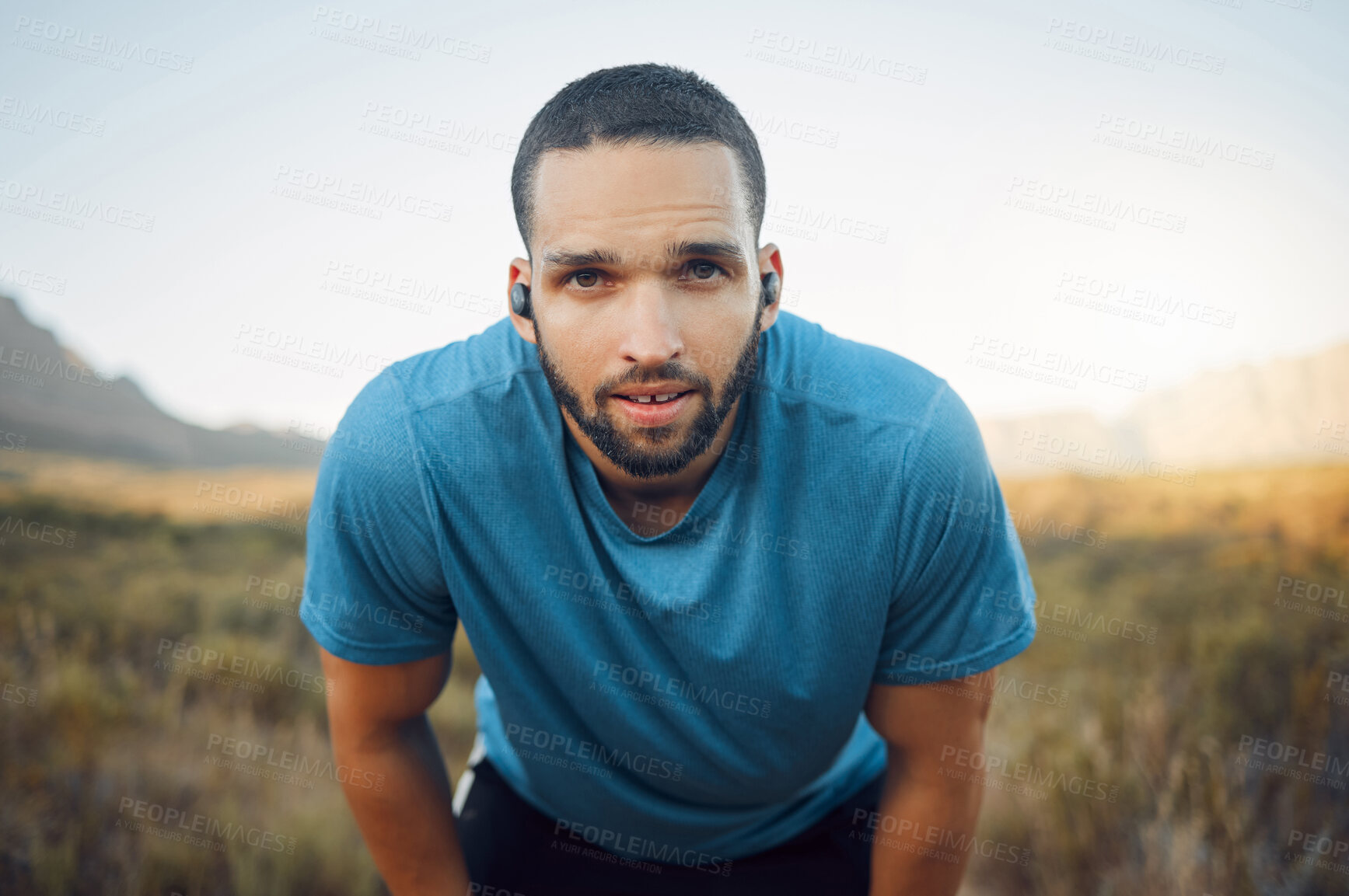 Buy stock photo Portrait of tired runner, music for motivation on earphones and man taking a break from a nature fitness run. Running for exercise, cardio health workout and enjoy freedom of sport training in nature