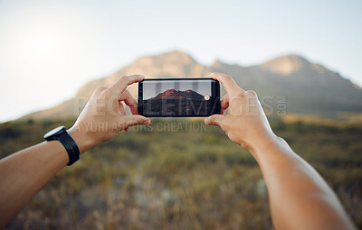 Buy stock photo Hands, phone and mountain picture in nature for adventure, travel and countryside in the outdoors. Hand of traveler taking a photo of the natural environment with mobile smartphone in South Africa