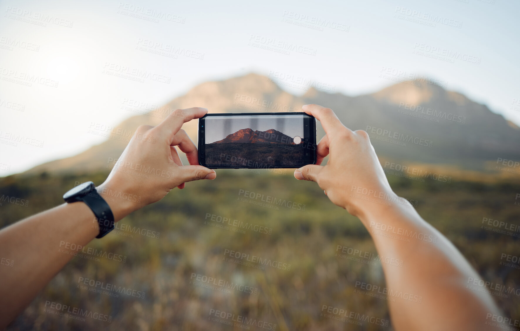 Buy stock photo Hands, phone and mountain picture in nature for adventure, travel and countryside in the outdoors. Hand of traveler taking a photo of the natural environment with mobile smartphone in South Africa