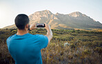 Mountain, hiking man and smartphone photography in nature, outdoors or countryside. Adventure, travel and man on 5g mobile taking landscape picture for online social media, good memory or post on web