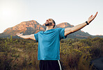 Mountain, sports man hands in air celebrate victory after fitness hike or climbing cardio adventure. Young happy male athlete, arms raised and wellness travel workout or outdoor runner success