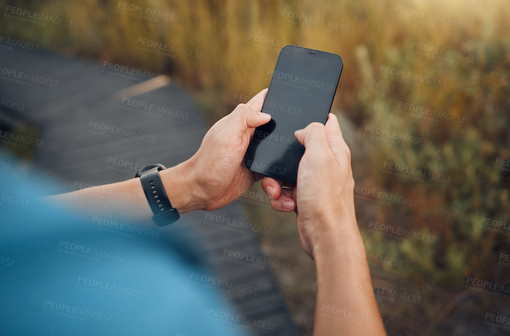 Buy stock photo Fitness, hands and mockup phone screen of runner exercising in nature. Technology, digital tracking and man using smartphone doing training exercise, workout and running on mountain with smart tech