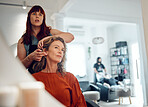 Mirror reflection of senior woman, hairdresser and salon studio employee working on client haircut, hair care or treatment. Designer hair salon, beauty spa service and stylist work on customer hair