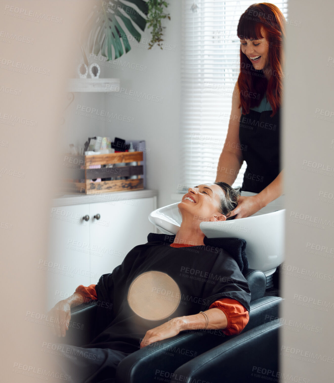 Buy stock photo Hairdresser, woman client and hair care to relax and smile after washing in the basin. Salon, beauty spa and professional stylist with a female customer for hairstyle change, pamper and good service