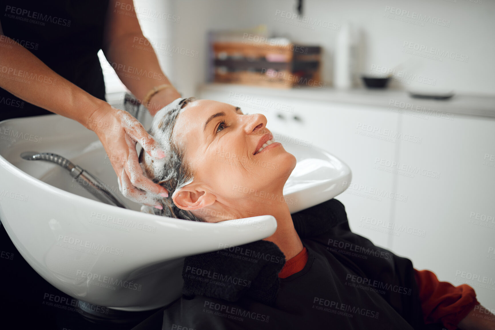 Buy stock photo Shampoo, hairdresser and happy customer at a salon cleaning, massage and washing head for luxury wellness treatment. Hands, happiness and beauty client with a smile at a grooming makeover in New York