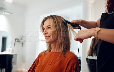 Buy stock photo Hairdresser, flat iron and woman in salon for hair appointment with happy customer. Stylist using hair straightener on client in beauty salon or hair shop for straight hair, heat treatment and style