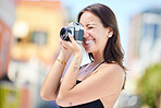 Travel, beauty and woman with camera in miami taking pictures of the city, buildings or town on vacation. Photographer, girl on holiday or vacation taking photo for happy memory, memories or moments