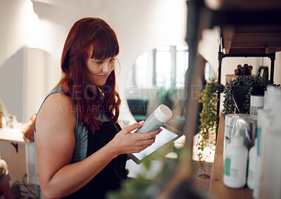 Buy stock photo Woman in salon, product inventory on tablet and small business entrepreneur with online order in Berlin. Professional hairdresser, plastic packaging and organize beauty boutique stock with technology