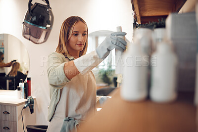 Buy stock photo Salon, professional hairdresser and hair care shampoo treatment on product display in boutique. Small business owner, cosmetic wellness woman working and beauty products shelf arrangement in store