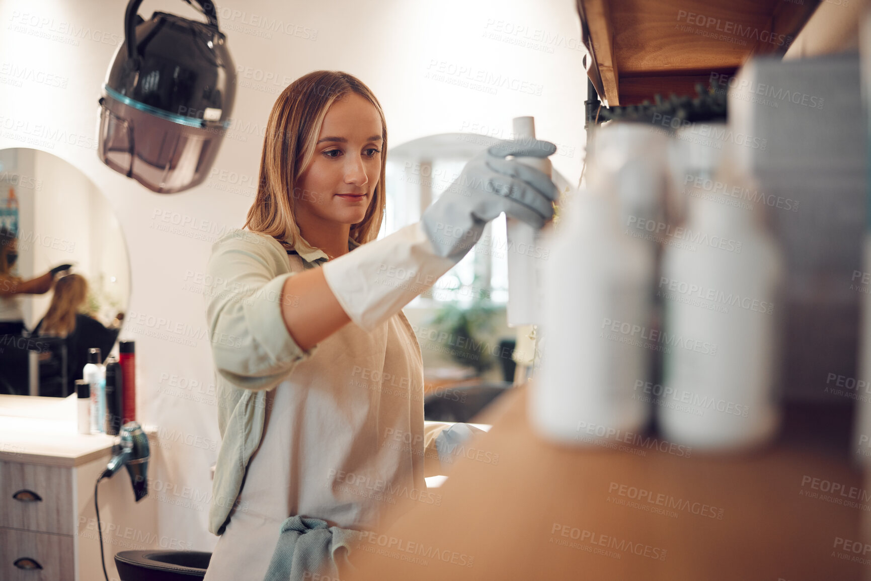 Buy stock photo Salon, professional hairdresser and hair care shampoo treatment on product display in boutique. Small business owner, cosmetic wellness woman working and beauty products shelf arrangement in store