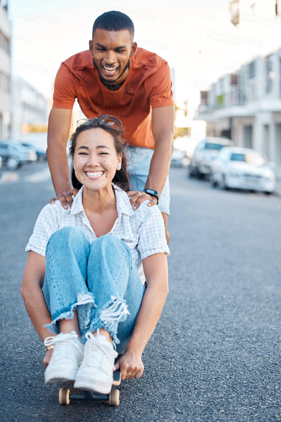 Buy stock photo Skateboard, young couple and fun, street style and playful sport date in urban cityscape. Gen Z fashion, man and woman happy, skateboarding and diversity, together and bonding outdoors in the city.
