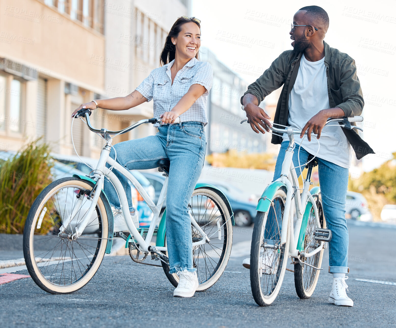 Buy stock photo Couple in street, bicycle and eco friendly travel, happy and clean carbon footprint in cityscape. Environment, transportation and urban, young man and woman, health and fitness, wellness and exercise