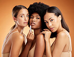 Lipstick, makeup and women with product for beauty against an orange studio background. Face portrait of a model group with facial cosmetics for skincare, body wellness and diversity of people