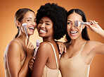 Makeup, beauty and women with brush for cosmetics against a brown mockup studio background. Face portrait of happy, smile and young model group with product for facial foundation and skincare