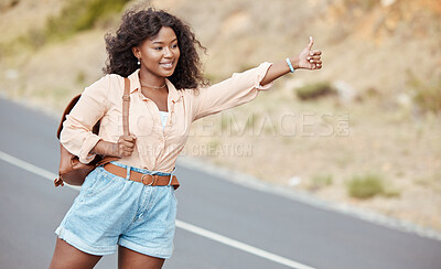 Buy stock photo Black woman, travel and thumbs up on the road for lift in nature for assistance, help or trip in the outdoors. African American female traveler or hitch hiker with roadside hand gesture for transport