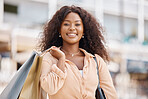 Shopping bag, happy black woman portrait and city customer smile for discount sales, luxury fashion products and town market trip. Wealthy, rich and young consumer on vacation travel in Ibiza Spain