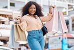 Excited black woman portrait, shopping bag and city consumer smile for happy sales, luxury fashion product and market choice from San Francisco mall stores. Wealthy young customer on holiday travel