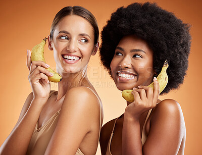 Buy stock photo Beauty, diversity and women on banana phone, black woman and friend act, smile and fun pretending to be on phone call. Playful, friendship and studio portrait of happy girls with fruit and fake chat.