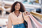 Black woman, retail shopping bag and city customer buying sales, luxury fashion product and market discount from mall store in San Francisco California. Portrait, happy and wealthy consumer in street