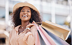 Shopping bag, happy black woman and travel customer smile for discount sales, thinking of luxury fashion choice and market in summer. Wealthy, rich and smile consumer on vacation in Ibiza Spain city