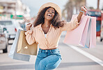 Excited black woman, shopping bag and urban customer celebrate sales, luxury fashion brands and summer market gift choice from Brazil mall store. Portrait, happy and wealthy young consumer on holiday