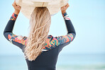 Surfing, beach and woman with surfboard on head, ready to surf in ocean. Blue sky, summer and girl doing water sports in Australia on vacation by sea. Wellness, adventure and fun activity in nature