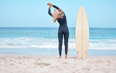 Surfing, stretching and woman surfer on beach standing by surfboard. Blue sky, ocean and girl ready to surf, doing stretch and water sports in Australia. Summer, wellness and fun activity in nature