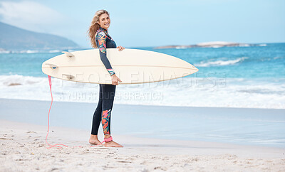 Woman, surfer and board by the ocean waves for sports exercise, hobby and swim in the summer outdoors. Portrait of a professional female standing on a beach in sport ready for surfing in South Africa