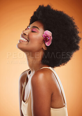 Buy stock photo Beauty, skincare and makeup with a model black woman in studio on an orange background with an afro and smile. Face, hair and happy with an attractive young female posing for cosmetics or wellness