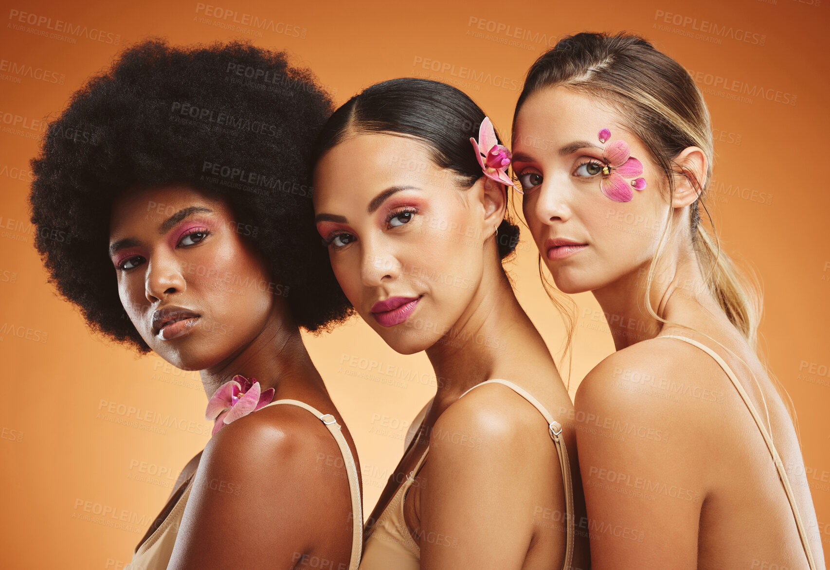 Buy stock photo Skincare, flowers and beauty portrait of women in studio for feminism, woman empowerment and cosmetics. Diversity, face and group of beautiful natural models with floral standing by orange background