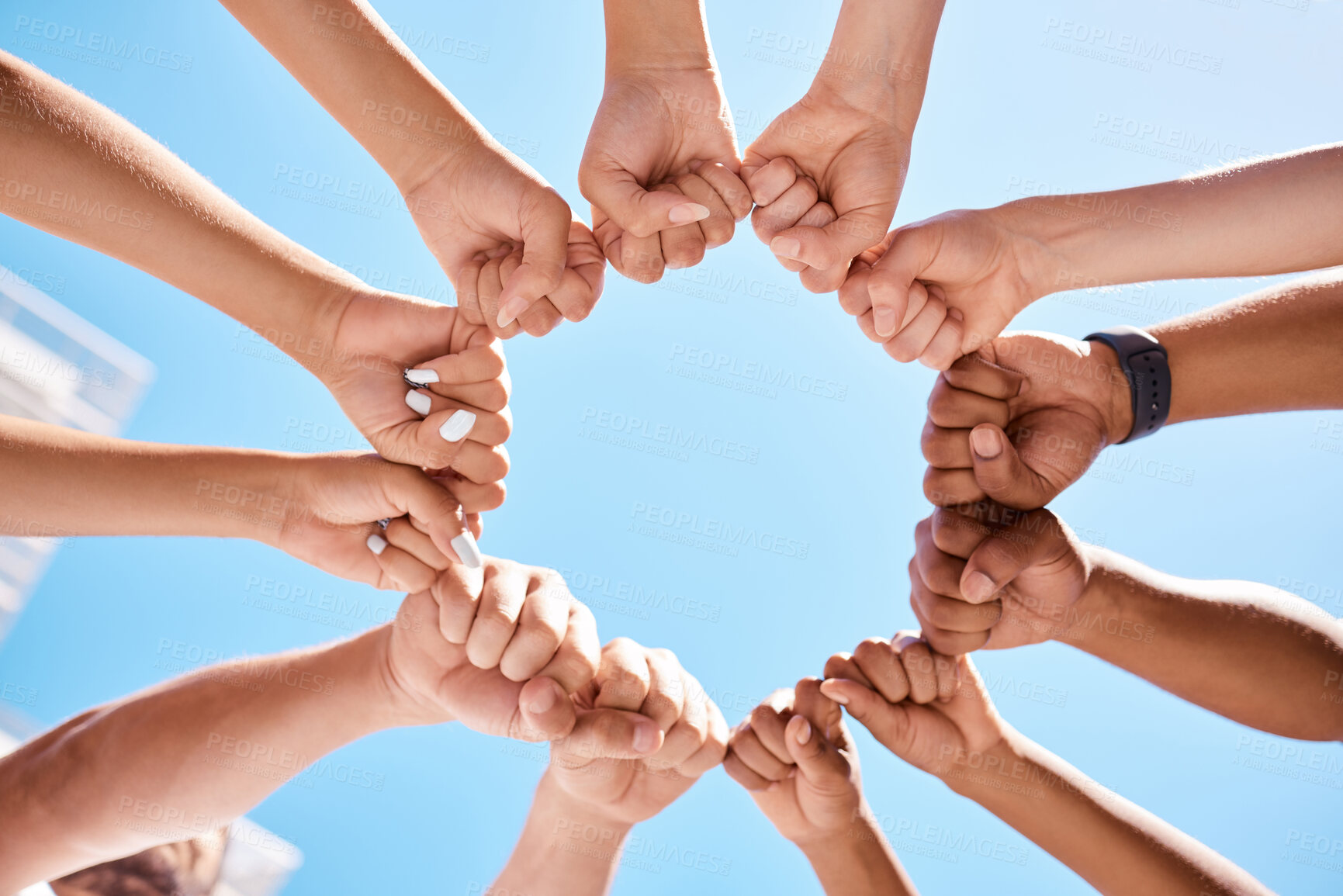 Buy stock photo Fist hands, circle and community support diversity people, protest group and freedom fight on blue sky background. Below solidarity, teamwork and motivation for justice goal, trust and society power