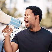 Megaphone, protest and angry black man talking at riot in Nigeria ...
