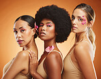 Makeup, skincare and beauty with model woman friends on a brown background in studio for diversity or wellness. Portrait, empowerment and natural with a female group posing together for inclusion