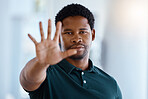 Black man, hands and stop or five gesture for sign, warning or halt raising palm against a blurred background. Portrait of a serious African American male showing number hand in vote, icon or voice