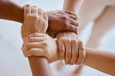 Buy stock photo Hands, together and solidarity with a group of people strong in unity from above for teamwork or collaboration. Trust, support and community with a team or partnership holding a wrist for motivation